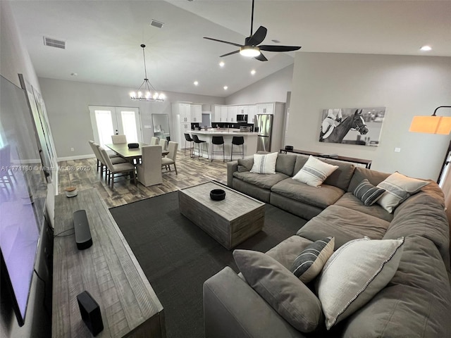 36 Lake Wood Cir, Ocala, FL 34482 - living area featuring wood finished floors, high vaulted ceiling, ceiling fan with notable chandelier, and visible vents