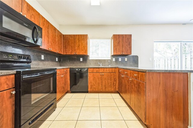 355 SE 20th Ave Unit 0, Homestead, FL 33033 - kitchen with a healthy amount of sunlight, black appliances, light tile patterned floors, and a peninsula
