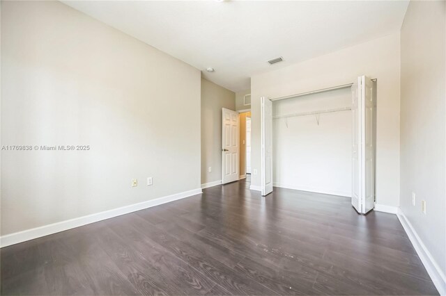 355 SE 20th Ave Unit 0, Homestead, FL 33033 - unfurnished bedroom featuring baseboards, visible vents, a closet, and dark wood finished floors