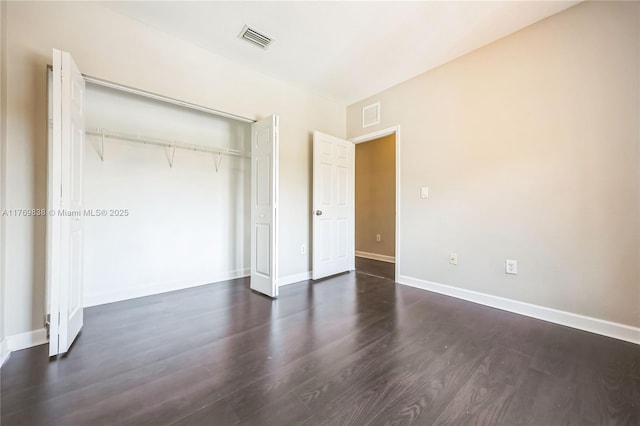 355 SE 20th Ave Unit 0, Homestead, FL 33033 - unfurnished bedroom featuring dark wood-style floors, baseboards, a closet, and visible vents