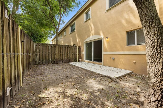355 SE 20th Ave Unit 0, Homestead, FL 33033 - back of house featuring a fenced backyard, stucco siding, and a patio area