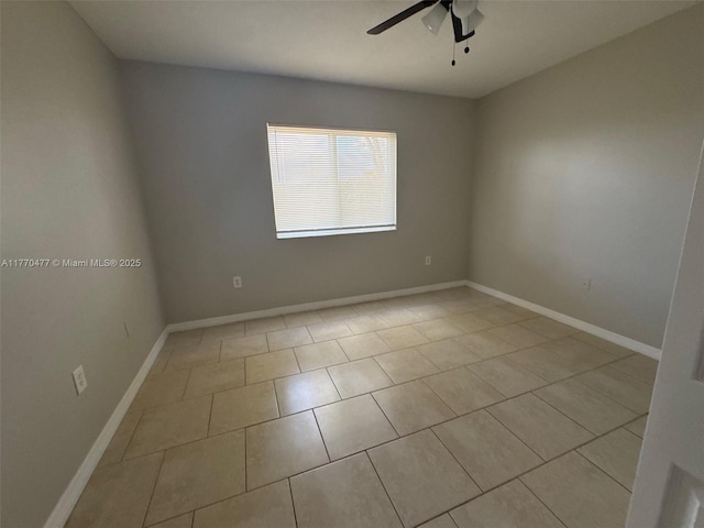 empty room featuring light tile patterned floors, baseboards, and ceiling fan