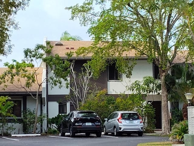 view of property featuring uncovered parking