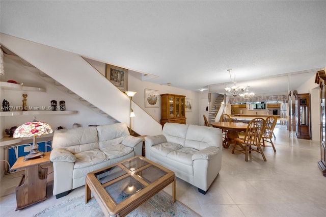 living room featuring a notable chandelier and stairway