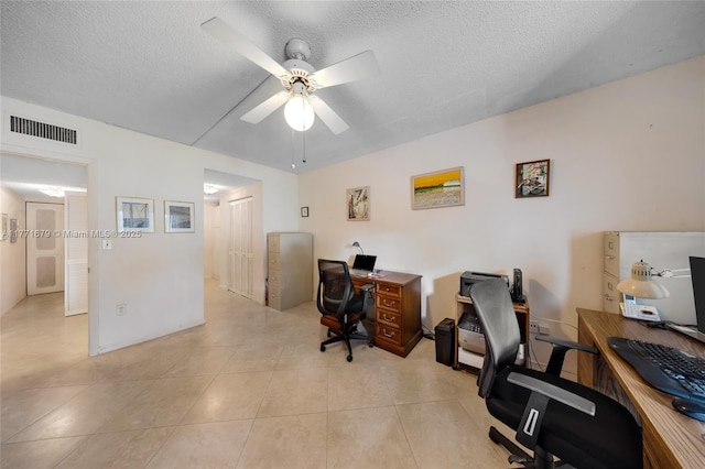 office area featuring visible vents, a ceiling fan, a textured ceiling, and light tile patterned flooring