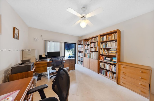 home office featuring a textured ceiling, ceiling fan, and tile patterned floors