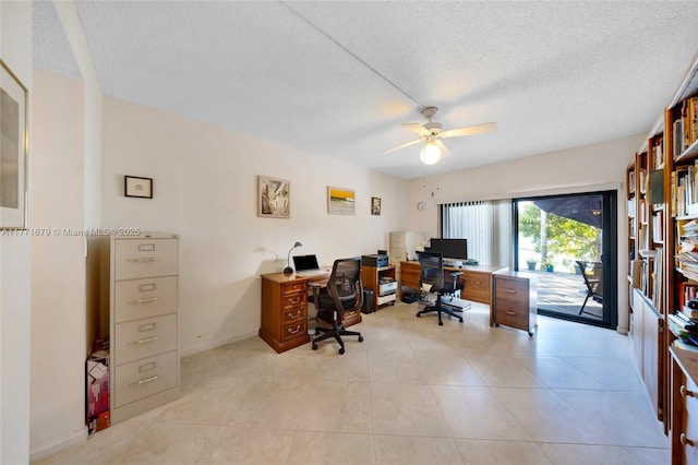 office area featuring light tile patterned floors, baseboards, a ceiling fan, and a textured ceiling