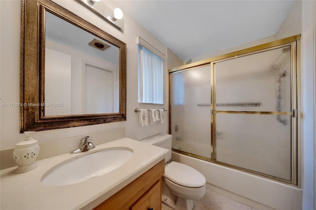 bathroom featuring vanity, combined bath / shower with glass door, and toilet