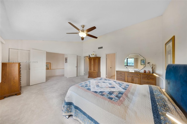 bedroom with light colored carpet, a ceiling fan, visible vents, and high vaulted ceiling