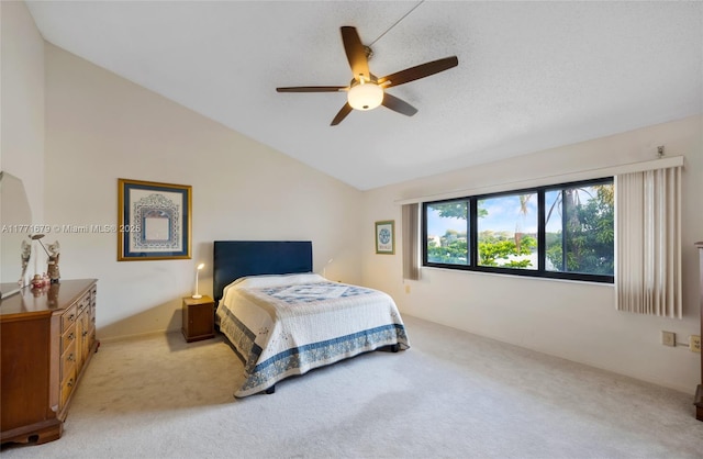 bedroom with a ceiling fan, vaulted ceiling, and light carpet
