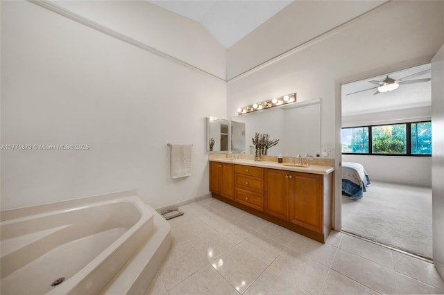 bathroom featuring a sink, tile patterned floors, double vanity, and a bath