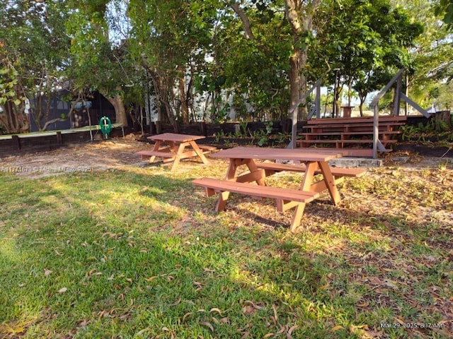 view of community with a lawn and fence