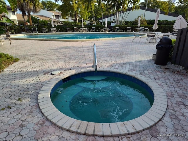 community pool featuring a patio and a community hot tub