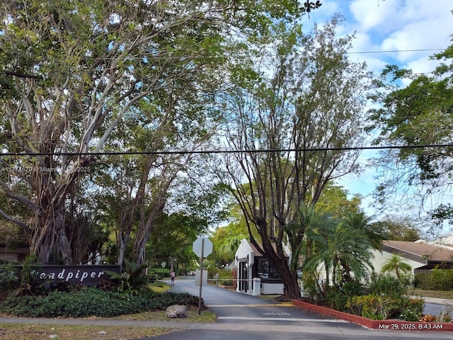 view of road featuring traffic signs and curbs