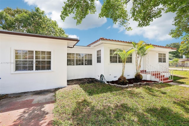 1121 SW 36th Ave, Miami, FL 33135 - exterior space with a tiled roof, a front yard, and stucco siding