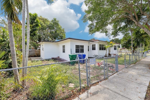1121 SW 36th Ave, Miami, FL 33135 - view of front of home with stucco siding, a gate, and a fenced front yard