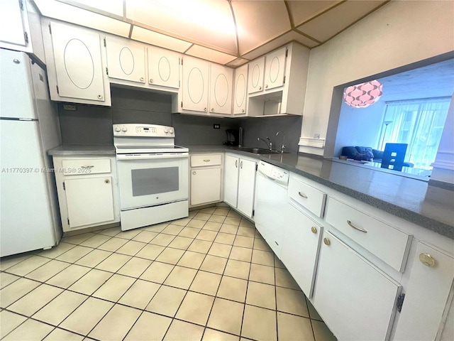 1680 NE 191st St Unit 107-2, Miami, FL 33179 - kitchen with light tile patterned flooring, a sink, white appliances, dark countertops, and decorative backsplash