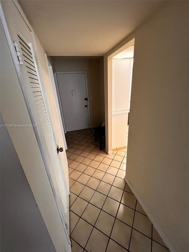 1680 NE 191st St Unit 107-2, Miami, FL 33179 - hall featuring baseboards and light tile patterned floors