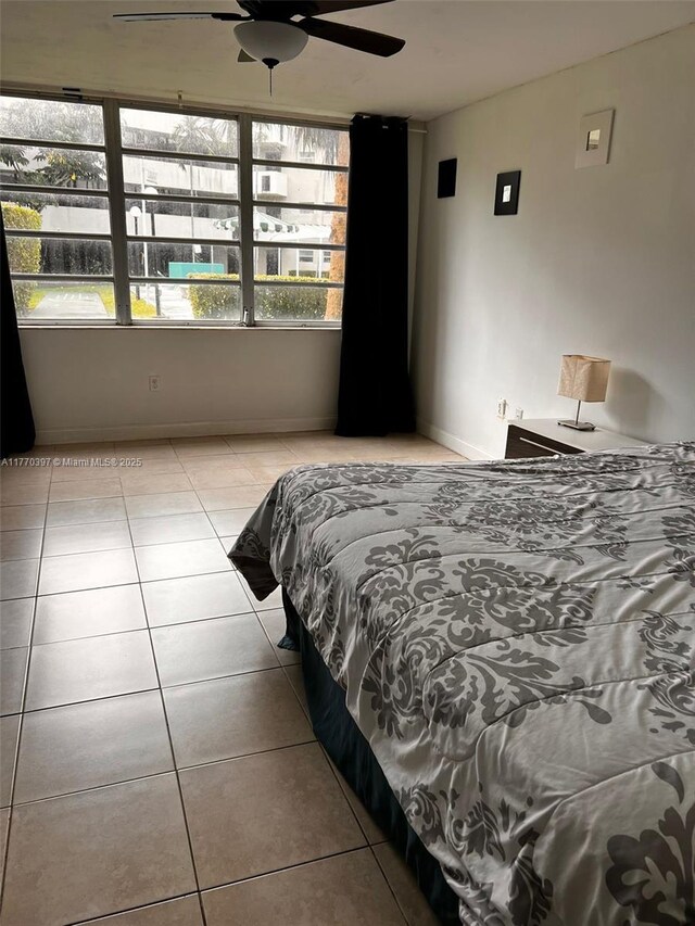 1680 NE 191st St Unit 107-2, Miami, FL 33179 - tiled bedroom featuring a ceiling fan and baseboards