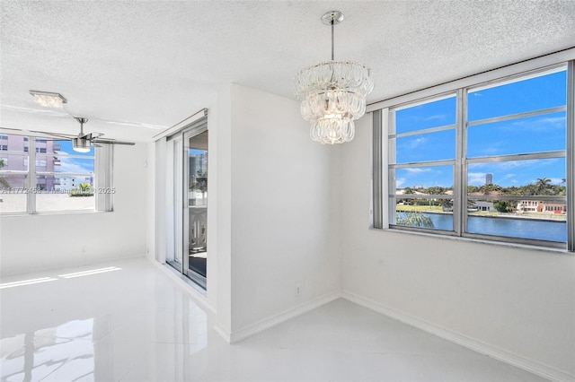 3113 S Ocean Dr Unit 410, Hallandale Beach, FL 33009 - unfurnished room featuring baseboards, a notable chandelier, and a textured ceiling