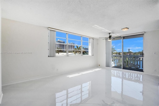 3113 S Ocean Dr Unit 410, Hallandale Beach, FL 33009 - empty room featuring baseboards, a textured ceiling, a healthy amount of sunlight, and ceiling fan