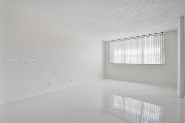 3113 S Ocean Dr Unit 410, Hallandale Beach, FL 33009 - unfurnished room featuring baseboards and a textured ceiling