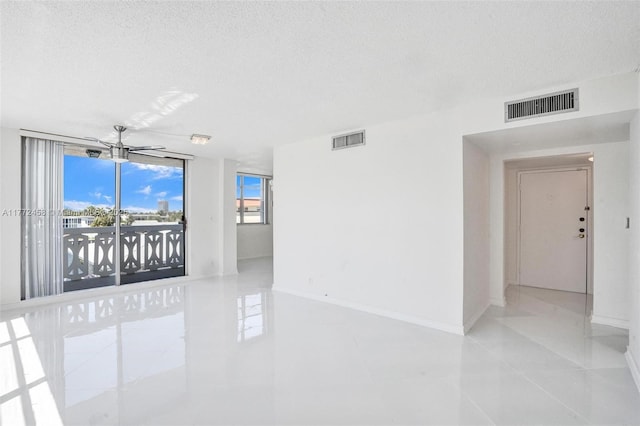 3113 S Ocean Dr Unit 410, Hallandale Beach, FL 33009 - tiled spare room with baseboards, visible vents, and a textured ceiling