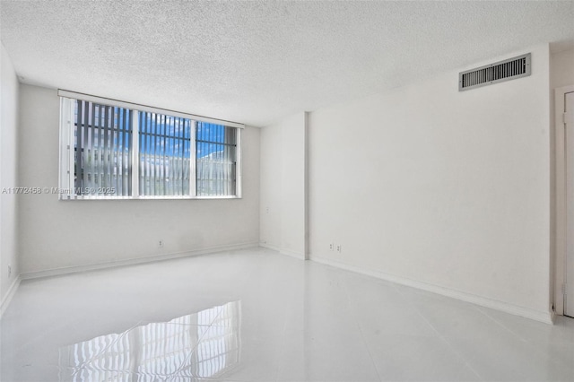 3113 S Ocean Dr Unit 410, Hallandale Beach, FL 33009 - unfurnished room with a textured ceiling, baseboards, and visible vents