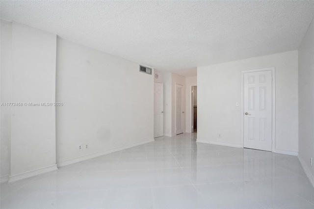 3113 S Ocean Dr Unit 410, Hallandale Beach, FL 33009 - empty room featuring baseboards, visible vents, and a textured ceiling