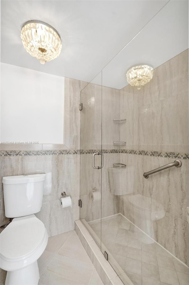 3113 S Ocean Dr Unit 410, Hallandale Beach, FL 33009 - full bath with tile walls, toilet, a stall shower, and tile patterned flooring