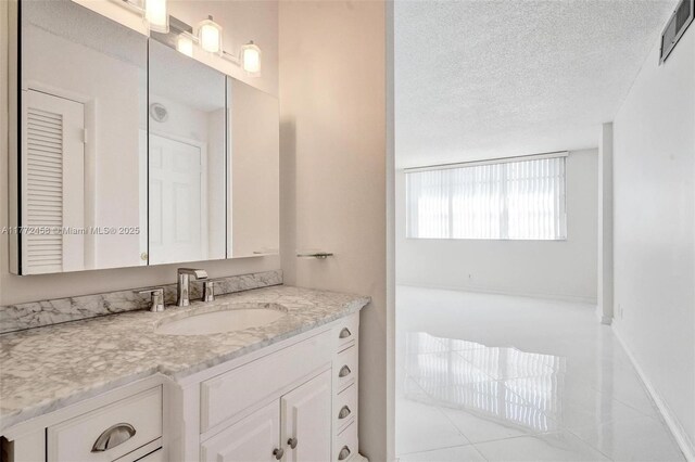3113 S Ocean Dr Unit 410, Hallandale Beach, FL 33009 - bathroom with a textured ceiling, visible vents, baseboards, tile patterned floors, and vanity