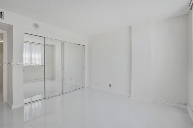 3113 S Ocean Dr Unit 410, Hallandale Beach, FL 33009 - unfurnished bedroom with baseboards, visible vents, a closet, and a textured ceiling