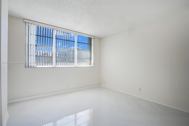 3113 S Ocean Dr Unit 410, Hallandale Beach, FL 33009 - empty room featuring baseboards and a textured ceiling