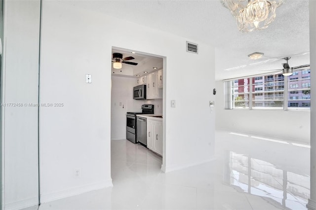 3113 S Ocean Dr Unit 410, Hallandale Beach, FL 33009 - corridor featuring light tile patterned flooring, a textured ceiling, visible vents, a chandelier, and baseboards