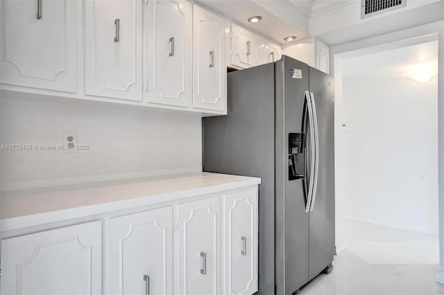 3113 S Ocean Dr Unit 410, Hallandale Beach, FL 33009 - kitchen with stainless steel fridge with ice dispenser, white cabinets, visible vents, and light countertops