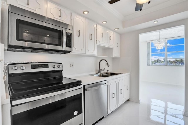 3113 S Ocean Dr Unit 410, Hallandale Beach, FL 33009 - kitchen featuring light countertops, ornamental molding, stainless steel appliances, white cabinetry, and a sink
