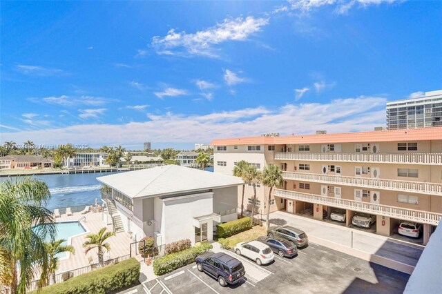 3113 S Ocean Dr Unit 410, Hallandale Beach, FL 33009 - view of building exterior featuring uncovered parking and a water view