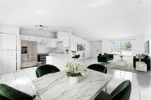 dining room with light tile patterned flooring and lofted ceiling