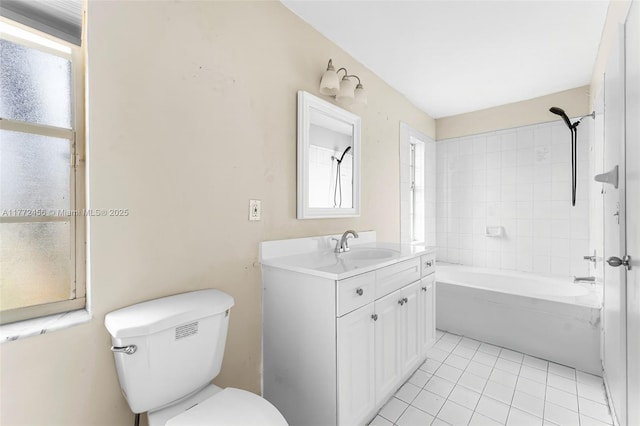 bathroom with toilet, vanity, tile patterned floors, and washtub / shower combination
