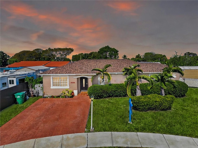 view of front of home with a front lawn and stucco siding