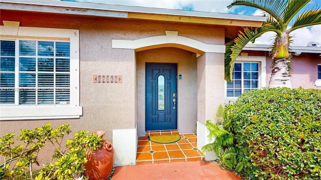entrance to property with stucco siding