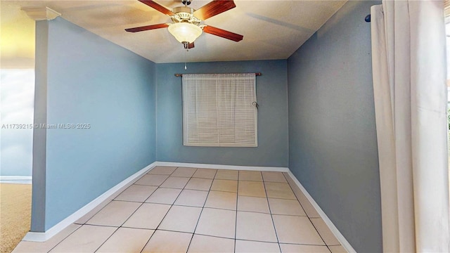 unfurnished room featuring tile patterned flooring, baseboards, and ceiling fan