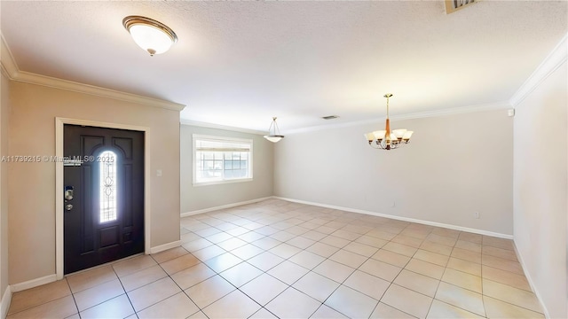 foyer featuring a chandelier and crown molding