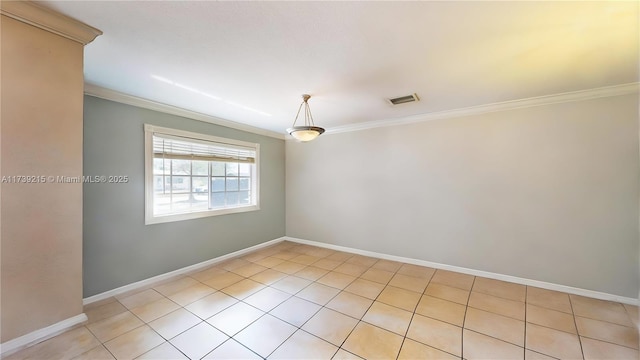 unfurnished room featuring crown molding, light tile patterned flooring, visible vents, and baseboards
