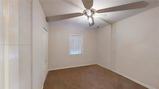 empty room with a ceiling fan, carpet flooring, and baseboards