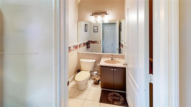 bathroom with toilet, tile patterned flooring, and vanity