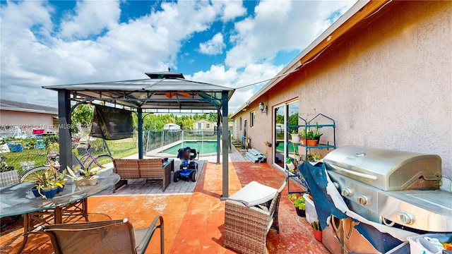 view of patio with a fenced backyard, a fenced in pool, a gazebo, and a grill