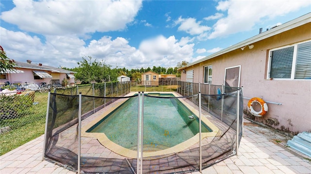 view of pool with a patio area, a pool with connected hot tub, and a fenced backyard