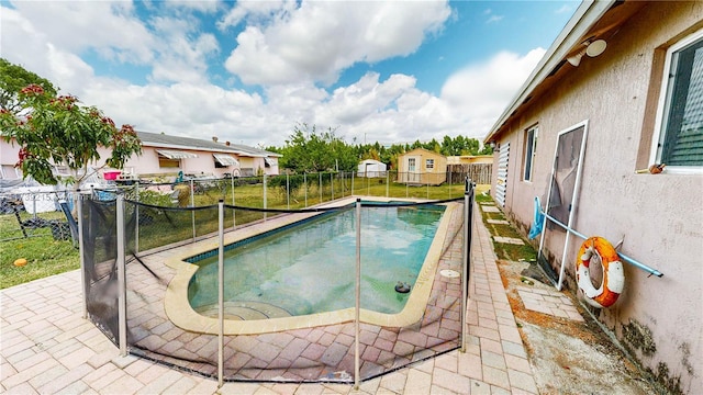 view of swimming pool with a fenced backyard, a patio, and a fenced in pool