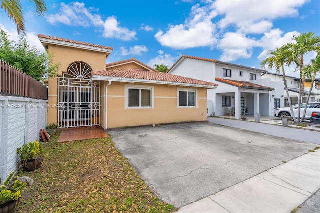 12332 NW 97th Ct, Hialeah Gardens, FL 33018 - mediterranean / spanish-style home with stucco siding, a tiled roof, and fence